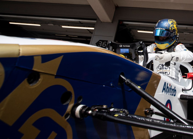 Driver preparing to enter the Mercantile F4 race car.